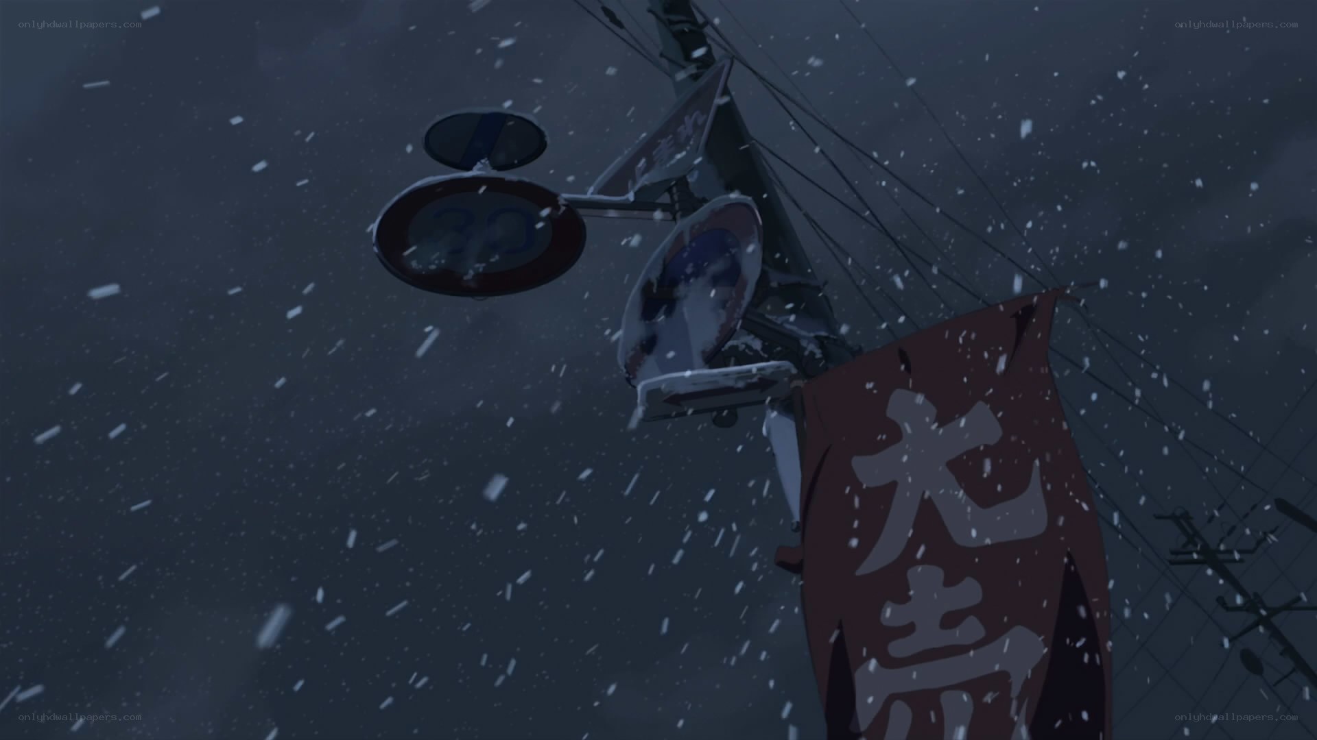 snowy street sign at night