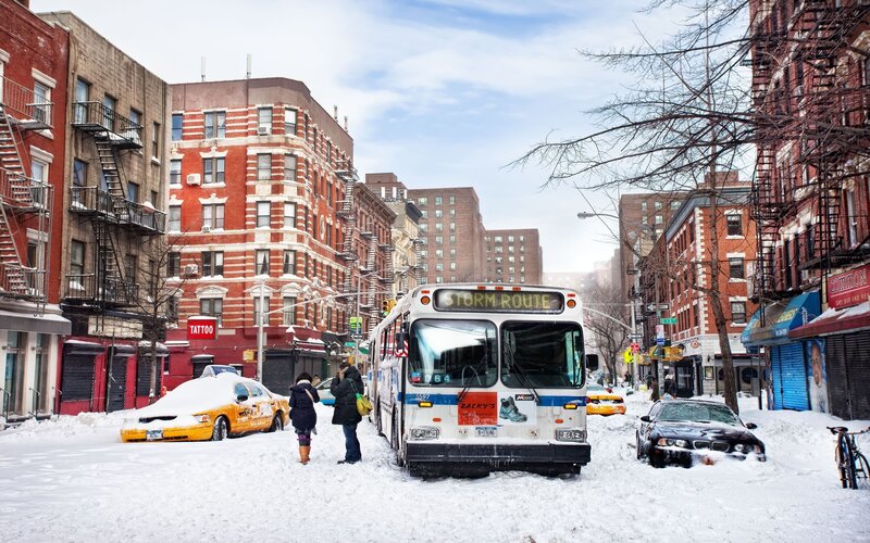 Snowy street with bus and taxis