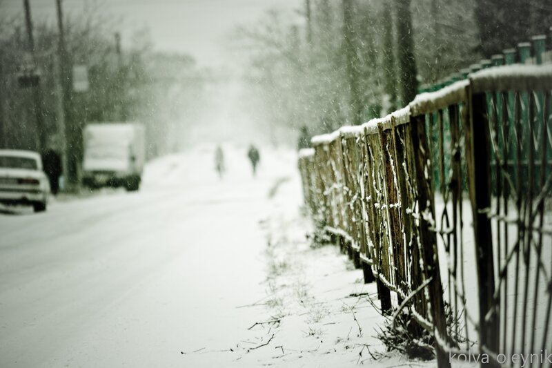 snowy street with fence