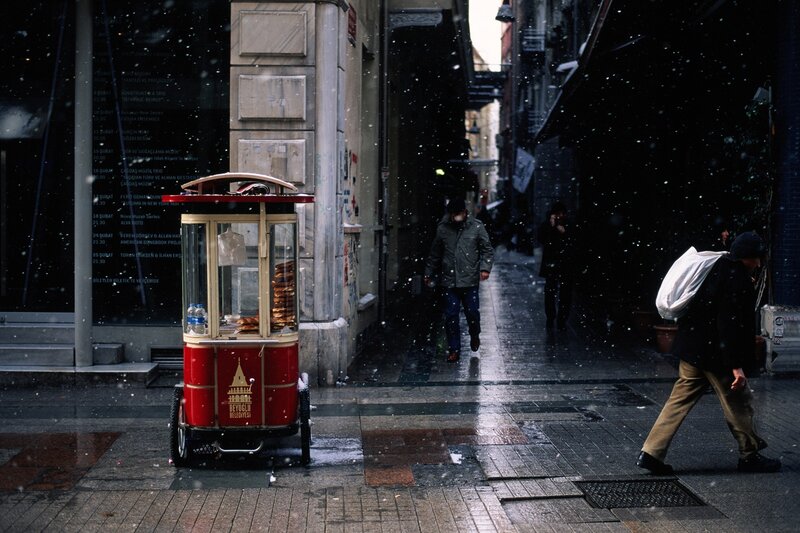 Snowy street with food cart