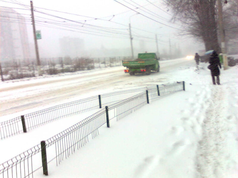 Snowy street with green truck