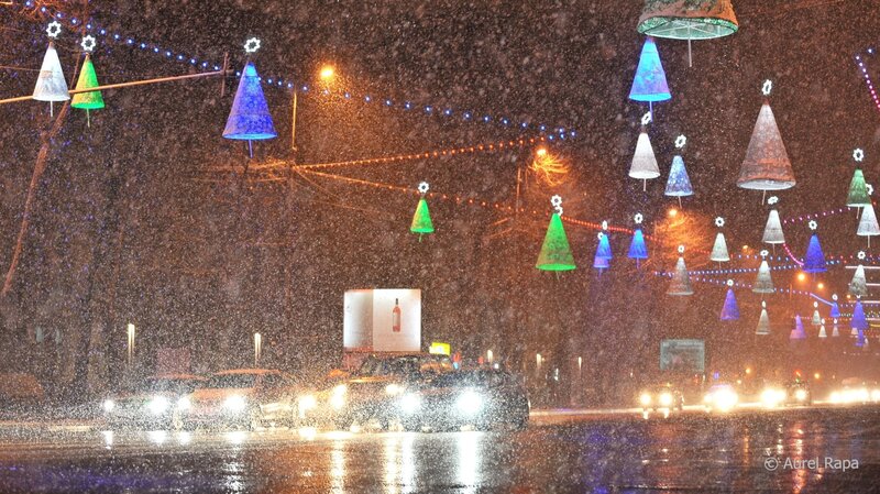 Snowy street with holiday lights