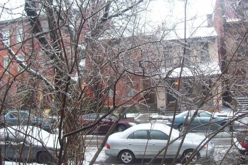 snowy street with parked cars