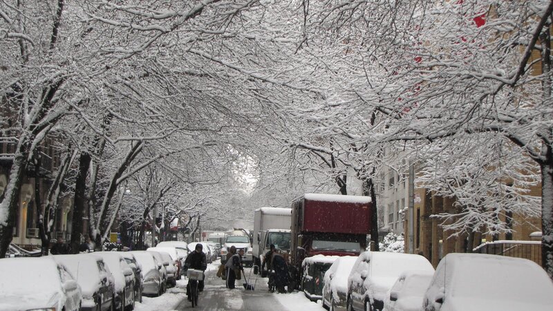 Snowy street with people and cars