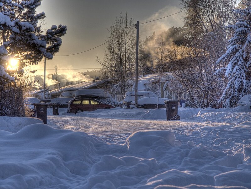 Snowy suburban street at sunrise