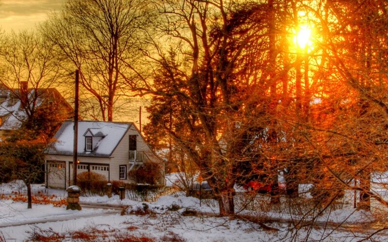 Snowy sunset in a quiet neighborhood