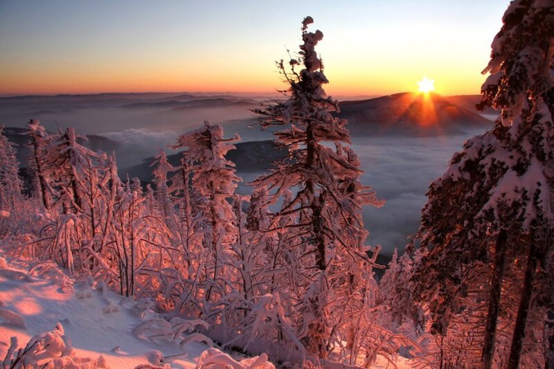 Snowy sunset over mountain valley