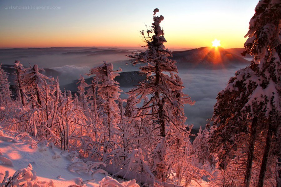 Snowy sunset over mountain valley