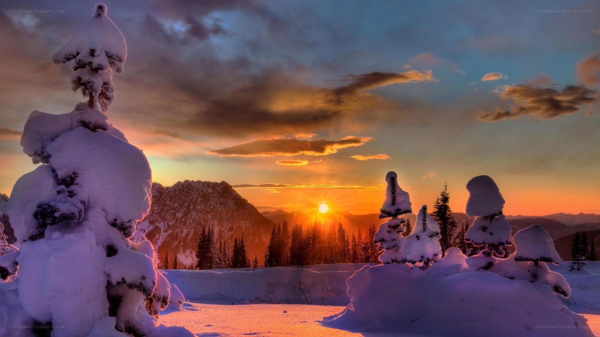 Snowy sunset over mountains