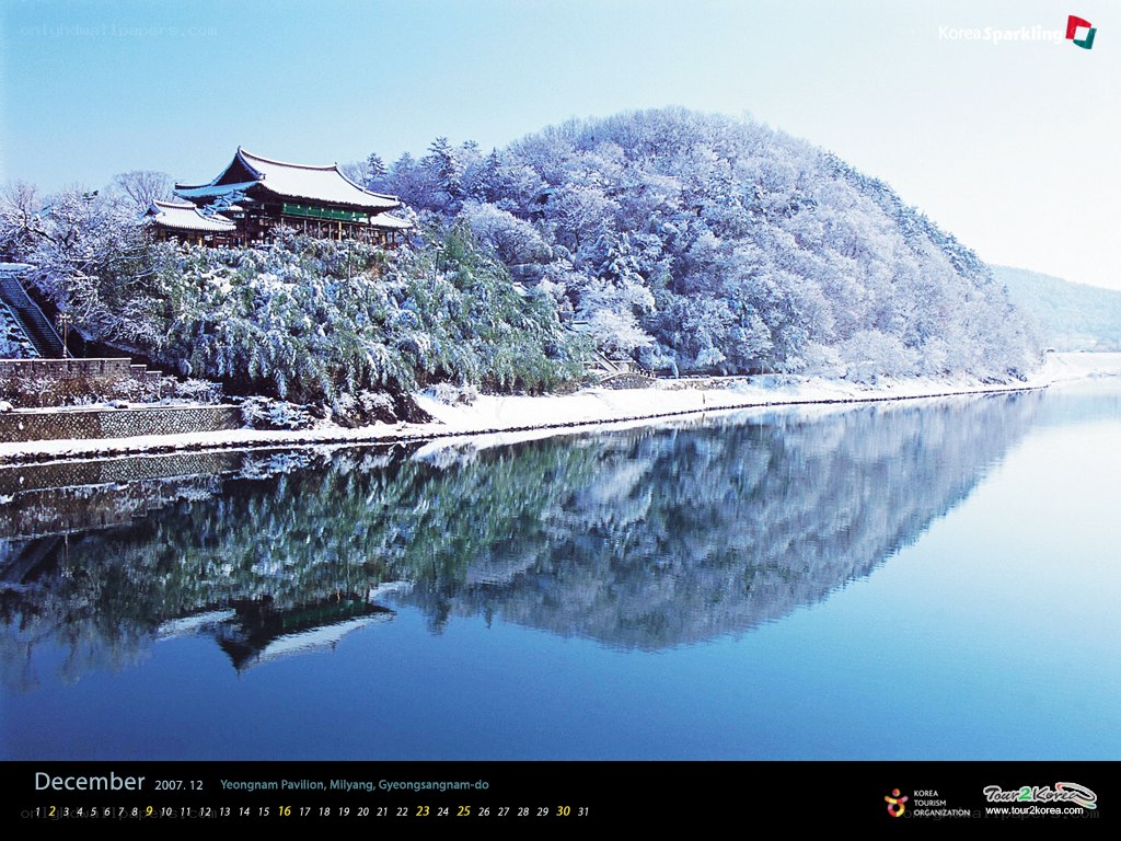 Snowy temple by a river
