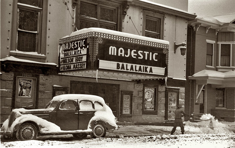 Snowy theater scene with vintage car
