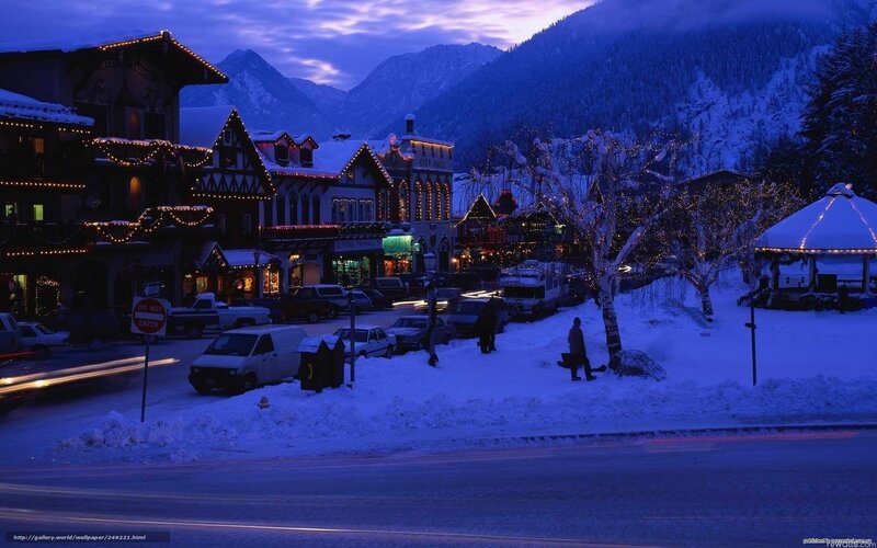 Snowy town at dusk with mountains