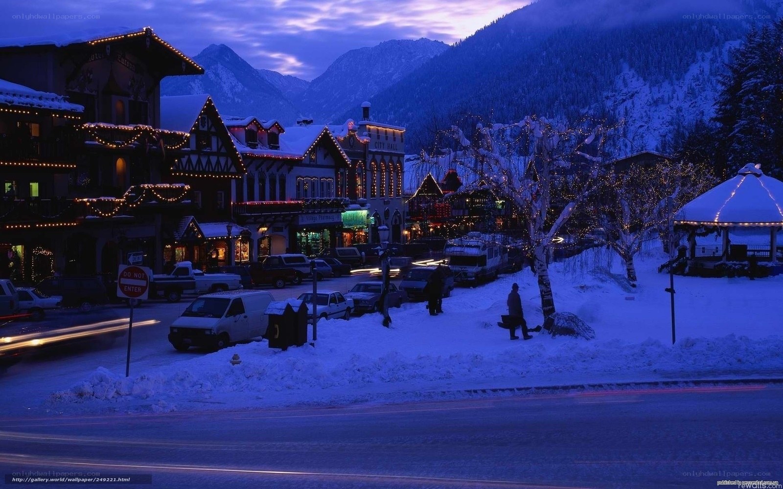 Snowy town at dusk with mountains