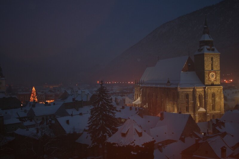snowy town at night with church