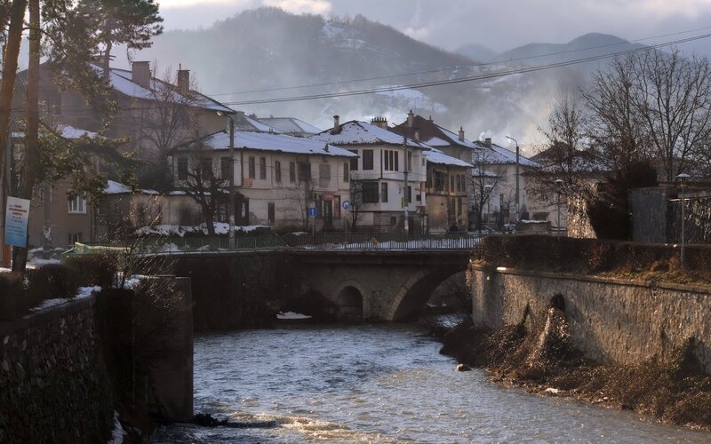 Snowy town by a river