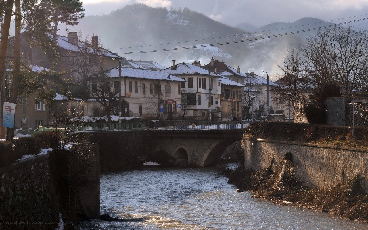 Snowy town by a river