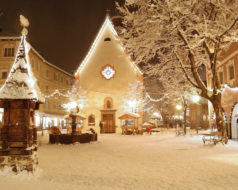 Snowy town square at night