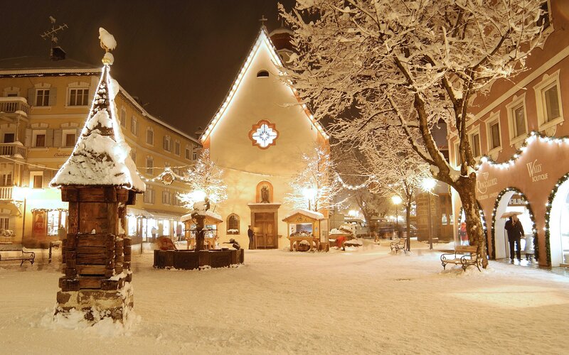 Snowy town square at night