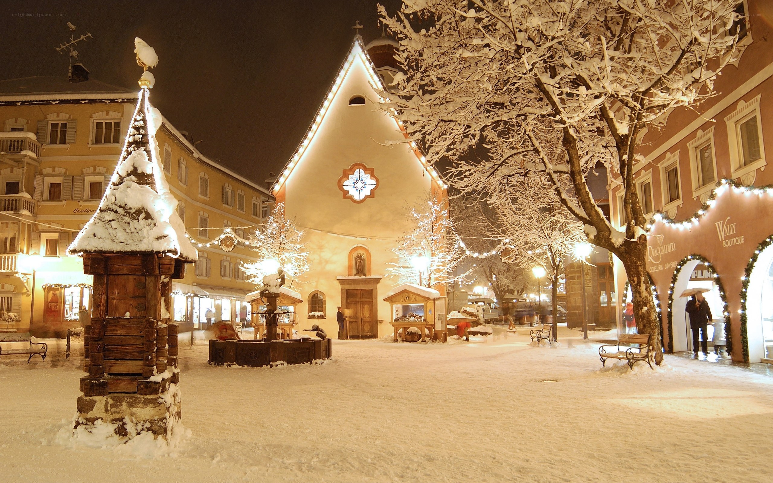 Snowy town square at night