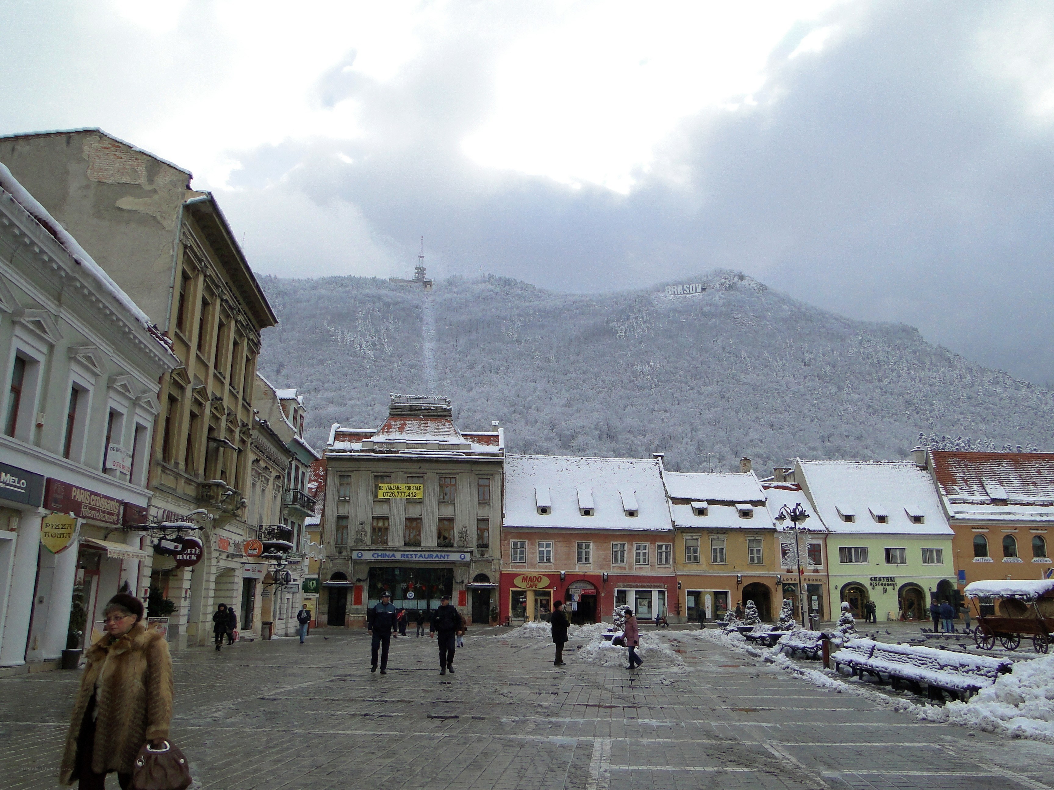 Snowy town square with mountain view