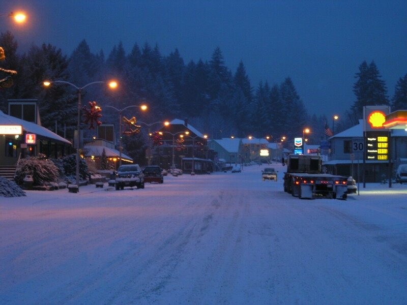 Snowy town street at dusk