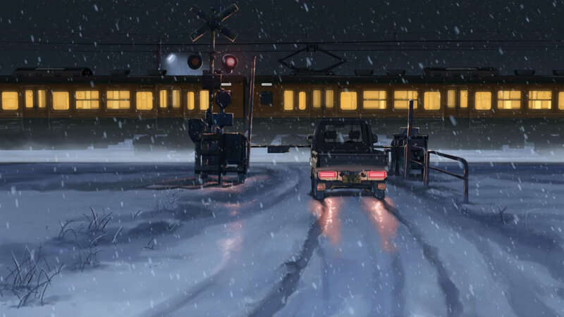Snowy train crossing at night