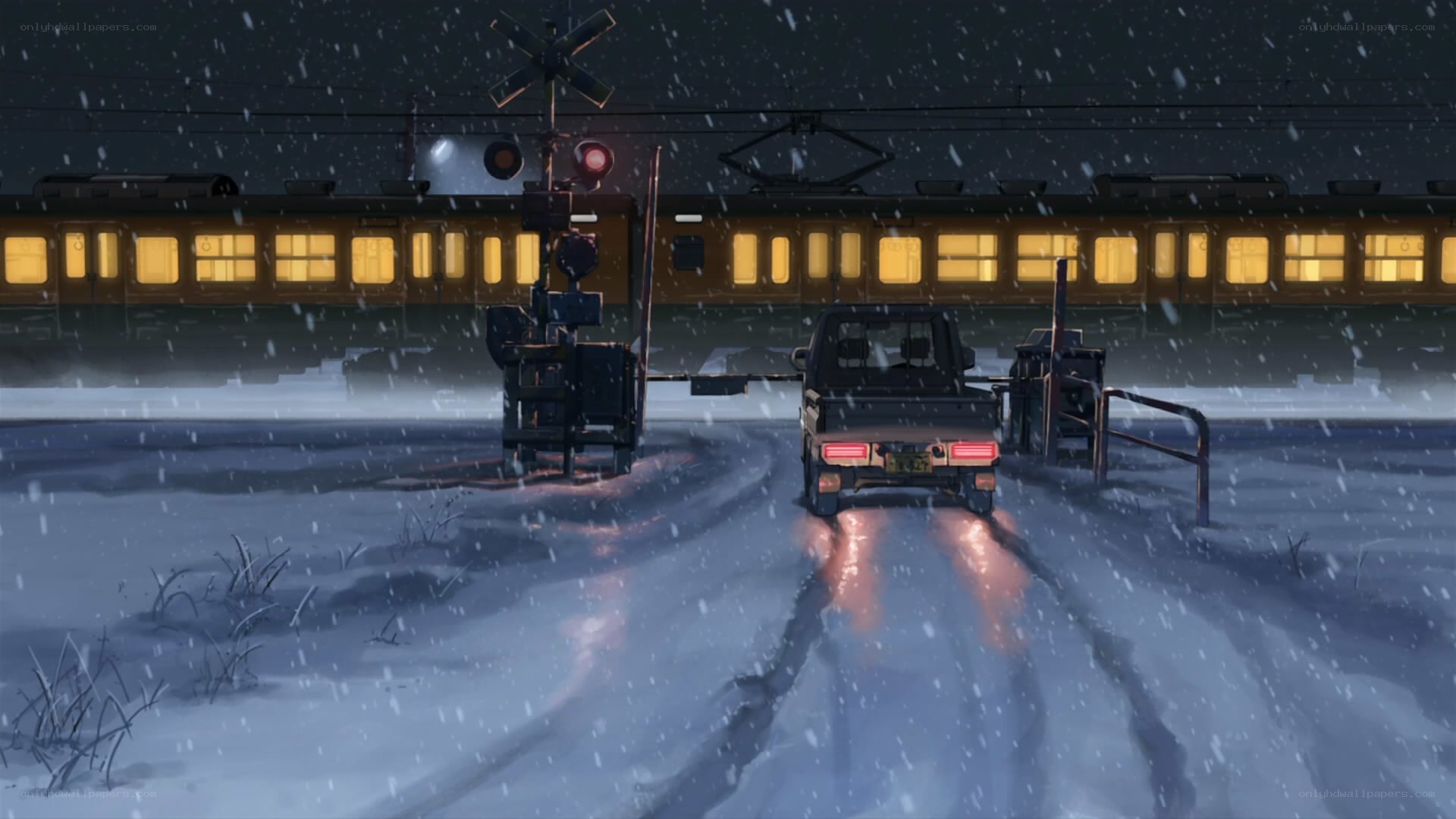 Snowy train crossing at night