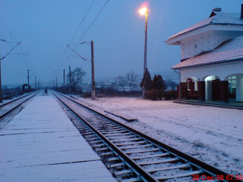 Snowy train station at dawn