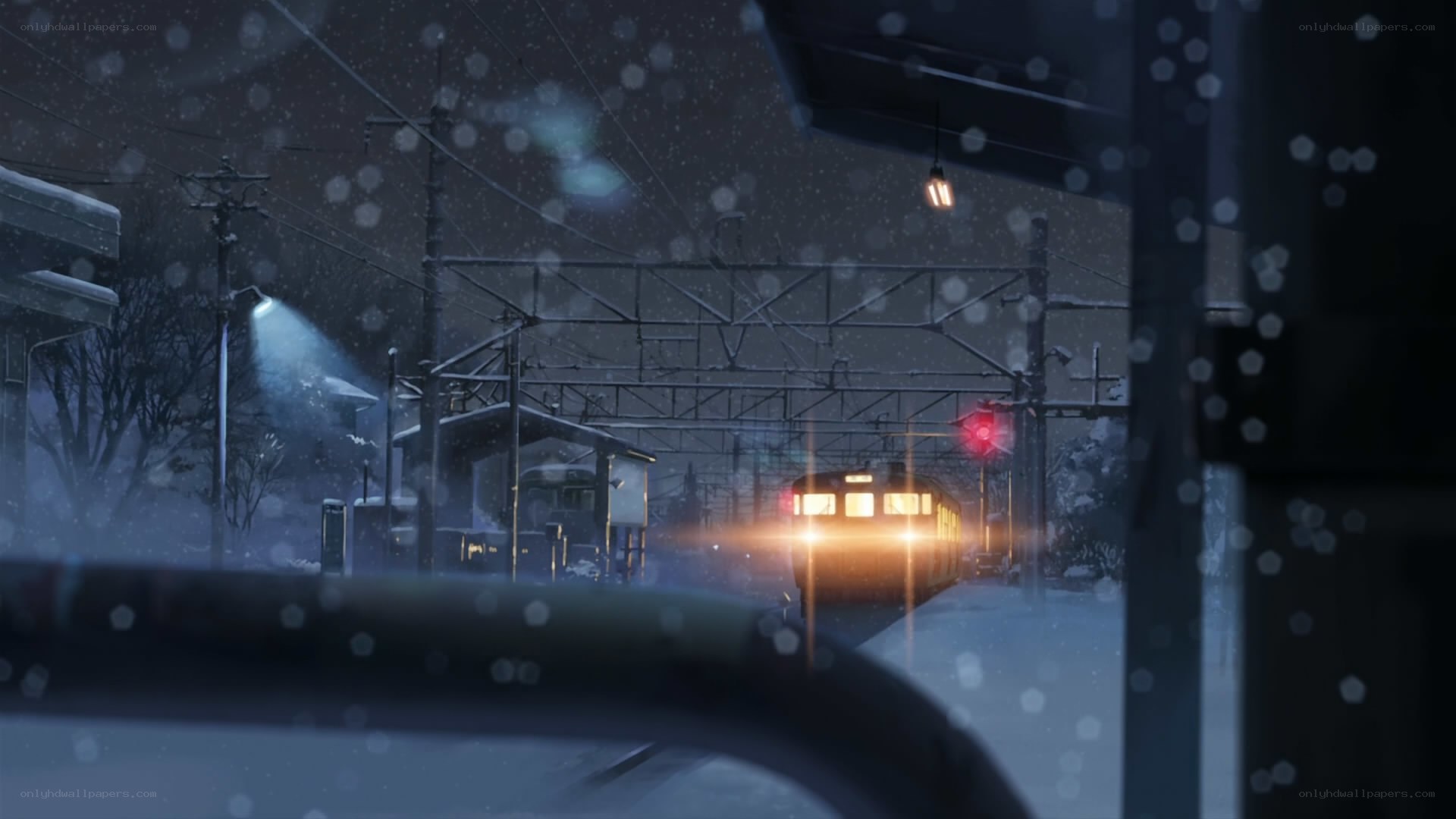 Snowy train station at night