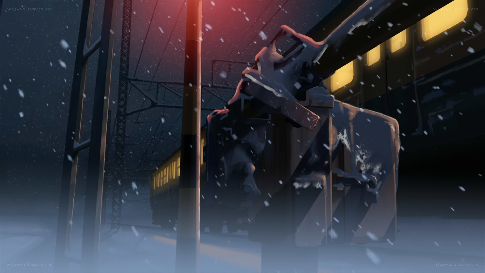 Snowy train station at night