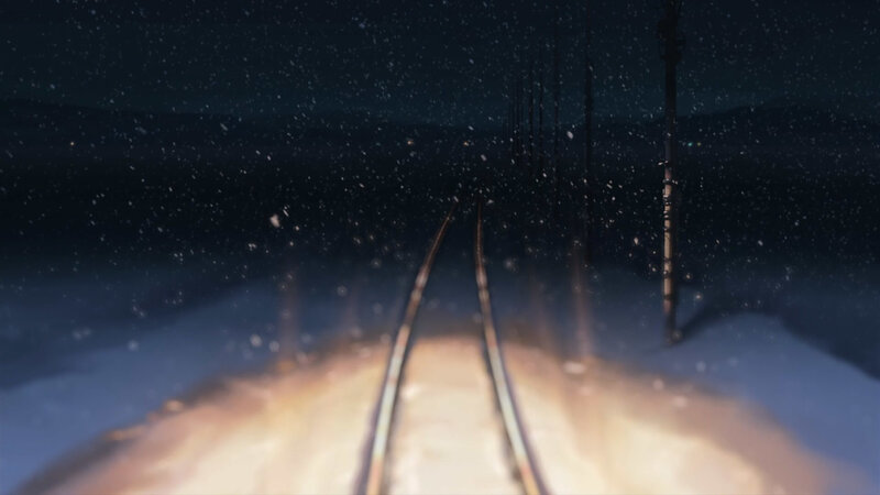snowy train tracks at night