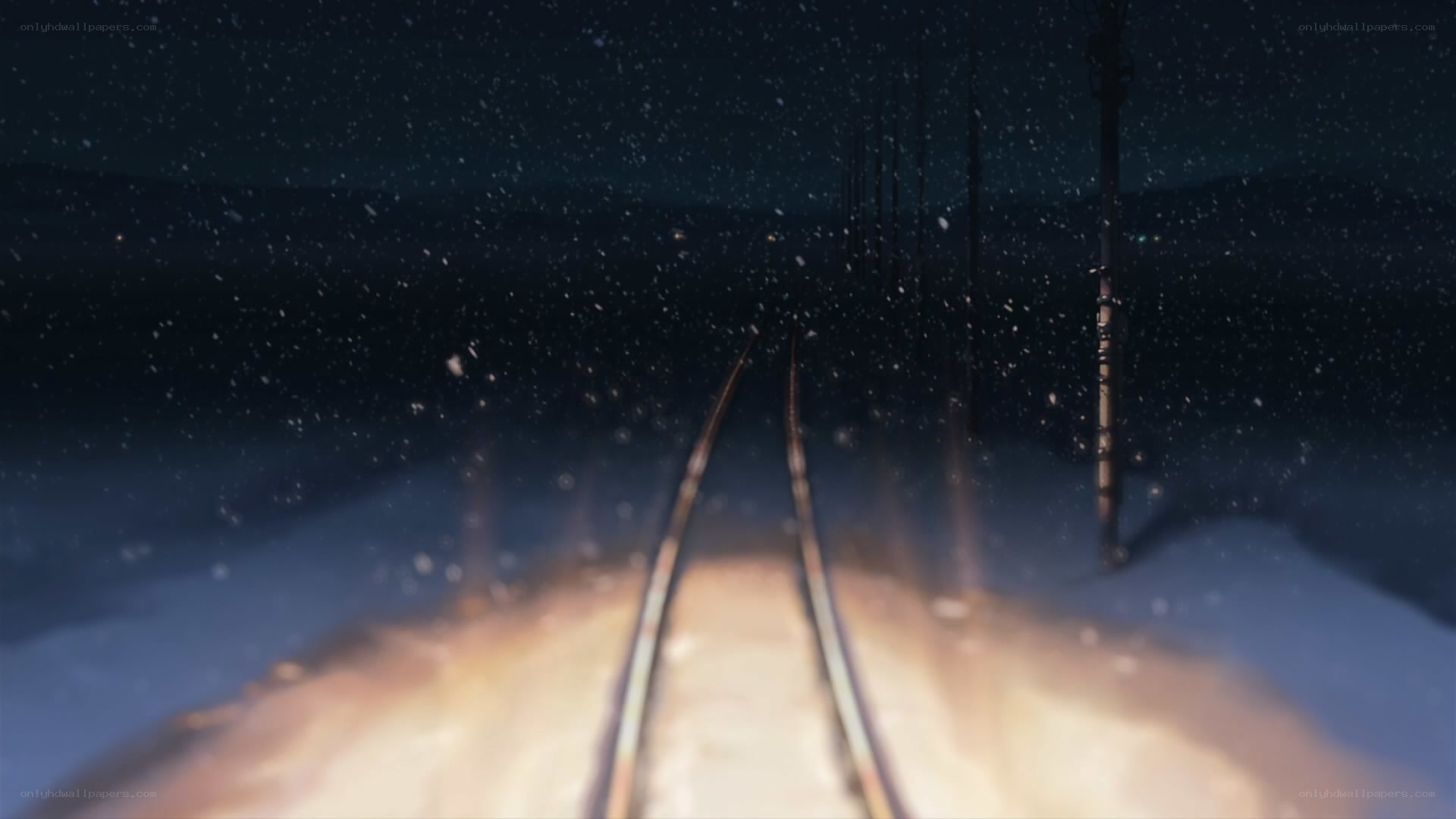 snowy train tracks at night