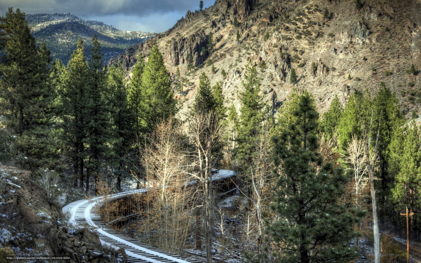 Snowy train tracks in mountain valley