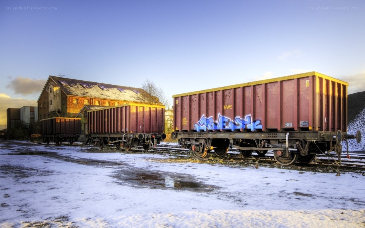snowy train yard at dusk
