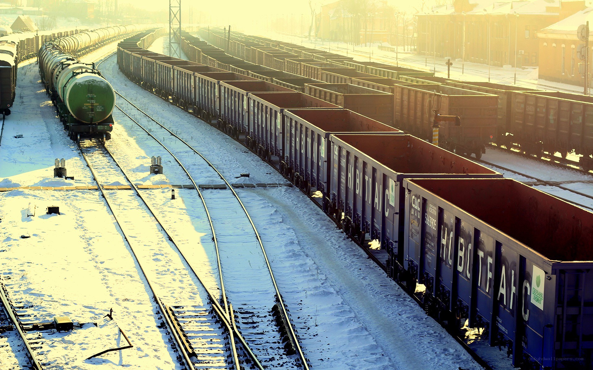 Snowy train yard at sunrise