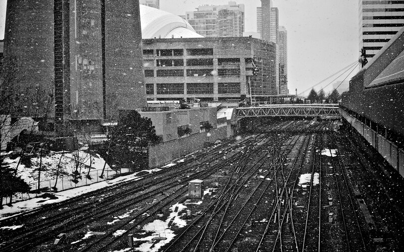 Snowy train yard in city