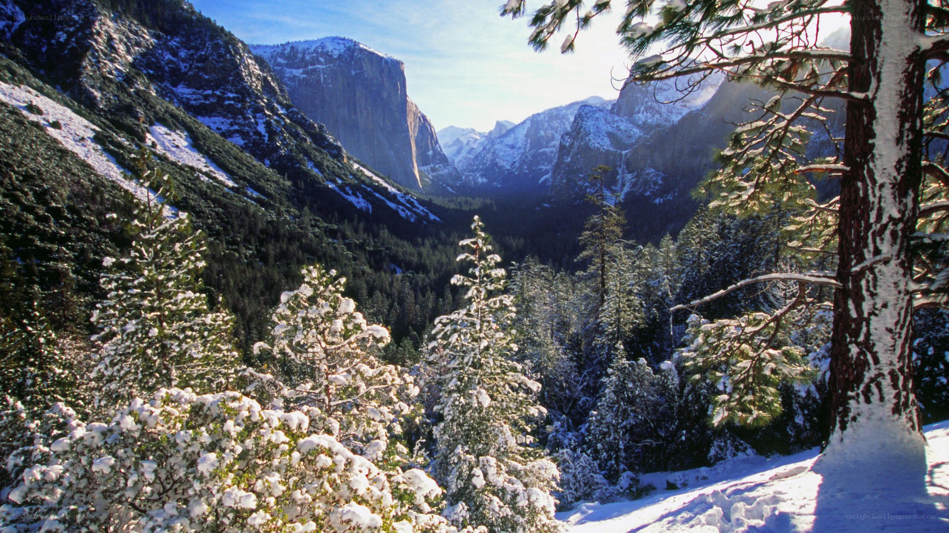 Snowy valley with granite cliffs
