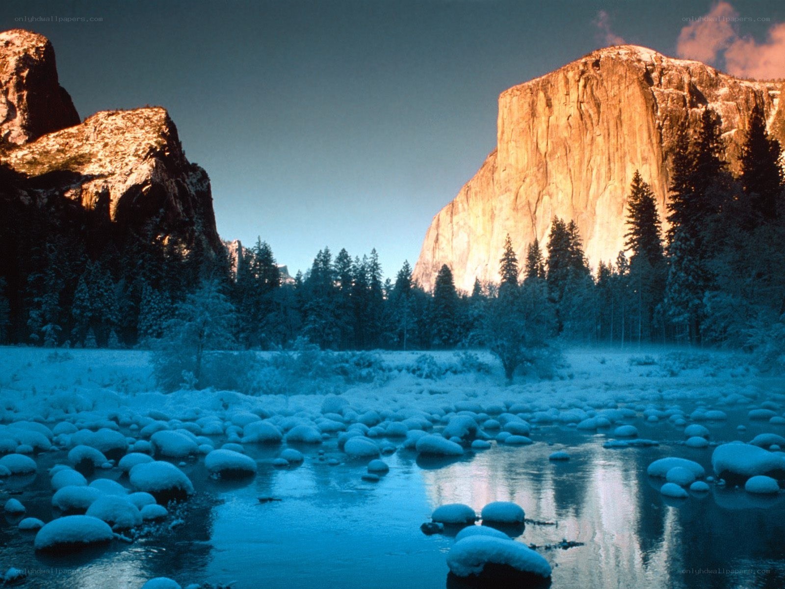 Snowy valley with river and cliffs