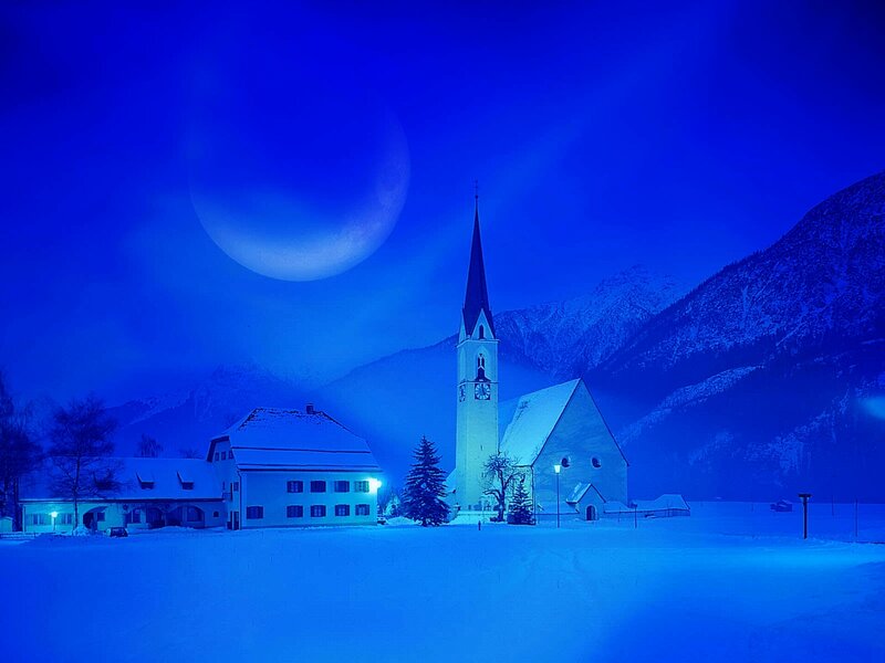 Snowy village at night