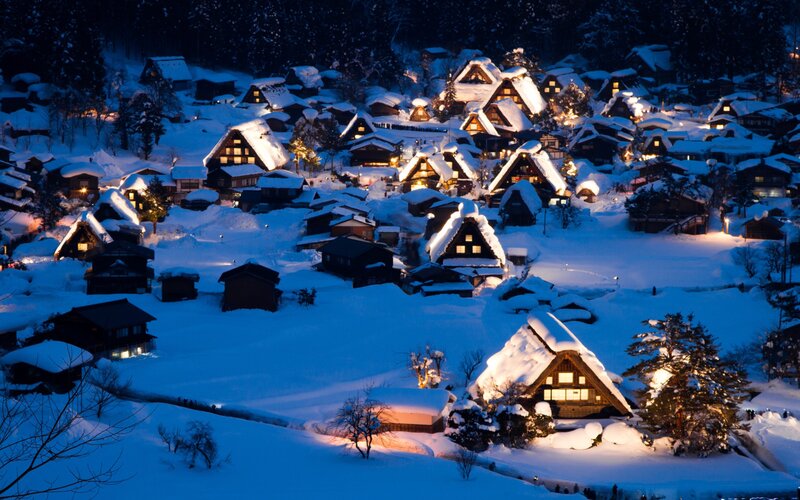 Snowy village at night