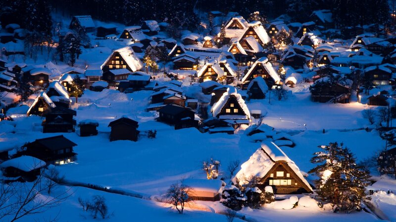 Snowy village at night