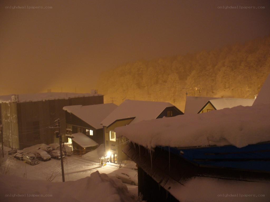 Snowy village at night