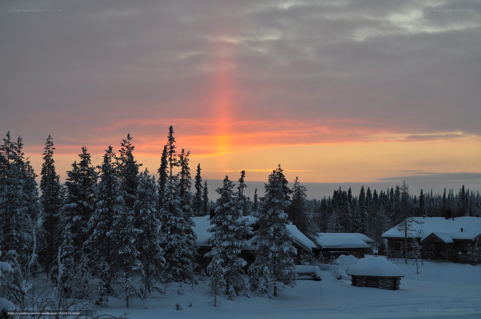 Snowy village at sunset