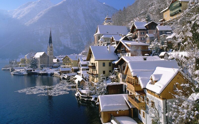 Snowy village by a lake
