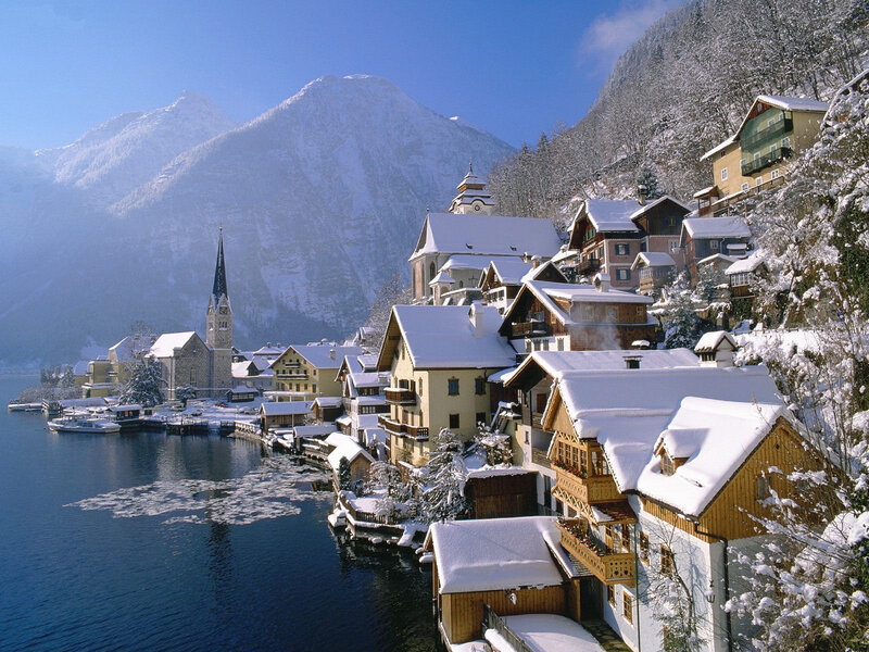 Snowy village by a lake