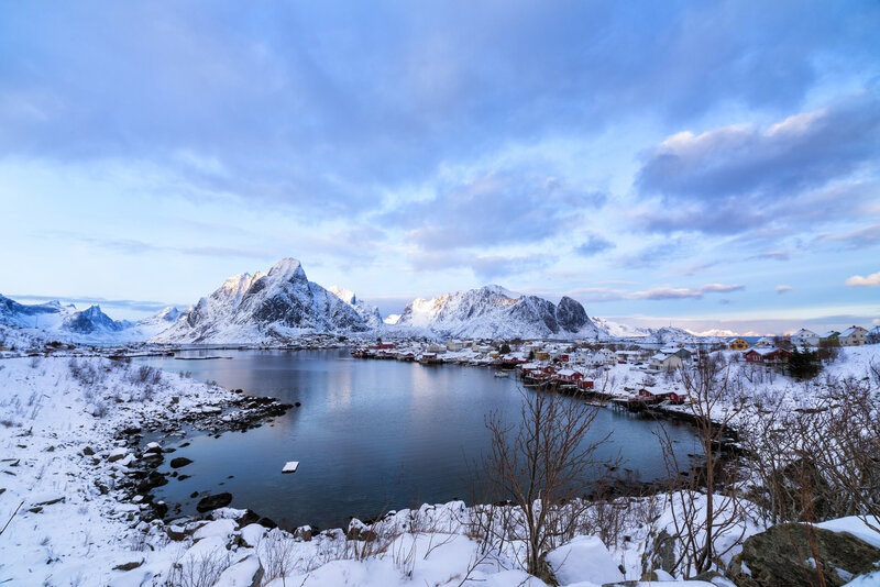 Snowy village by the fjord