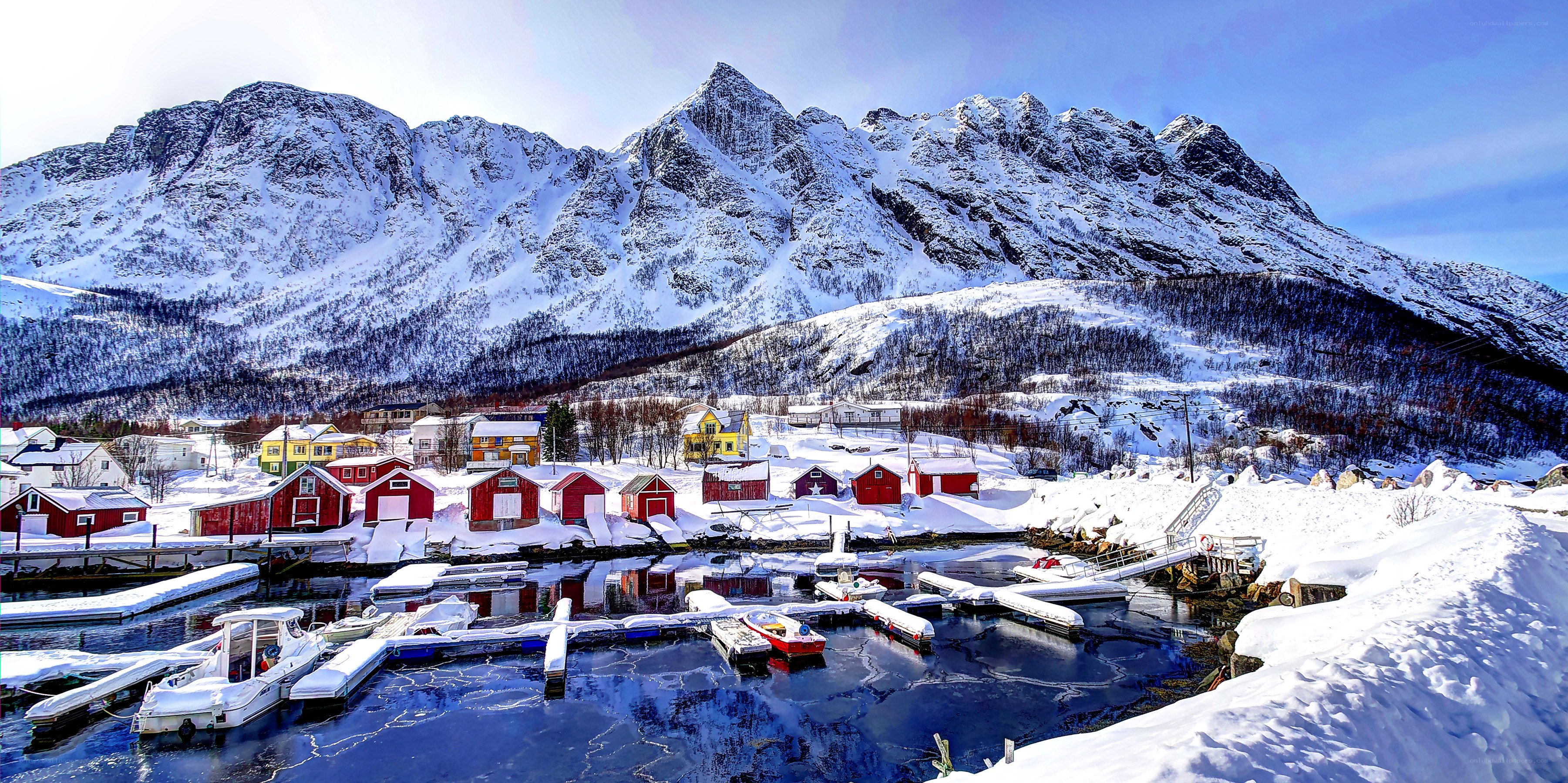 Snowy village by the fjord
