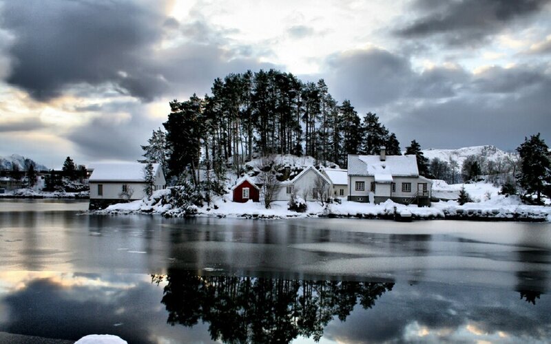 Snowy village by the water