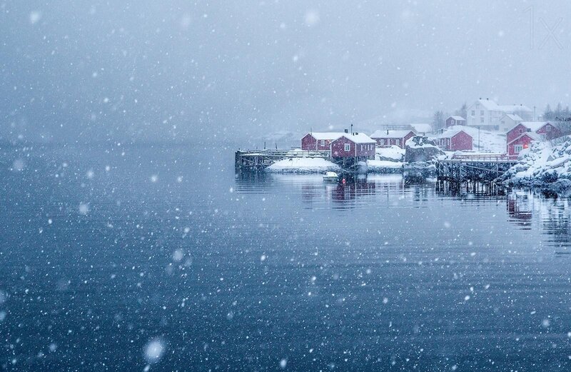 Snowy village by the water