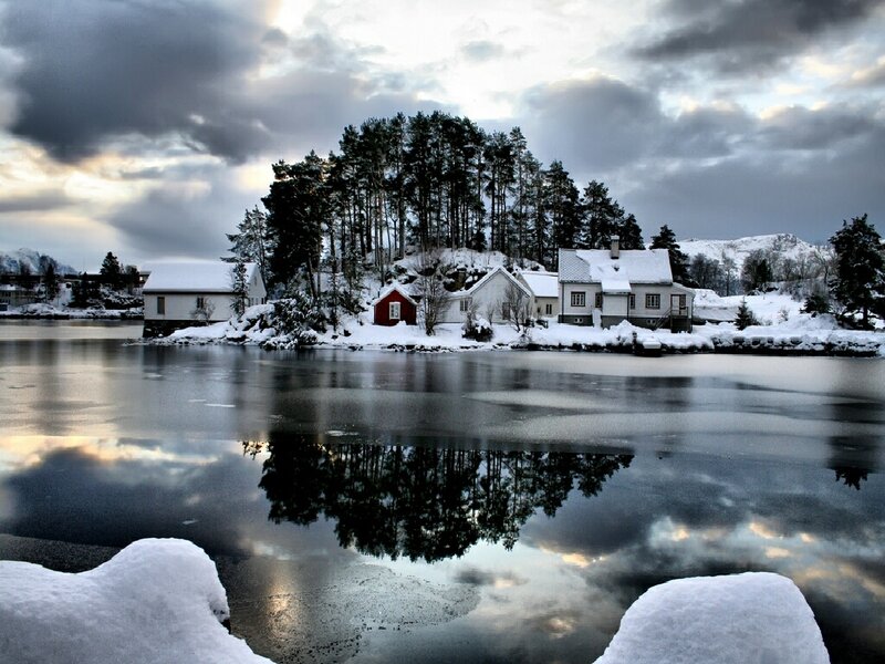 Snowy village by the water